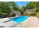 Backyard pool with diving board, chairs, and beautiful landscaping at 210 Farr Lake Dr, Tyrone, GA 30290