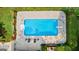 Aerial shot of pool with chairs and surrounding landscape, surrounded by lush greenery and flowers at 210 Farr Lake Dr, Tyrone, GA 30290