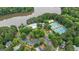 Aerial view of community amenities including tennis courts and a pool, all surrounded by lush trees at 405 Woodbrook Way, Lawrenceville, GA 30043