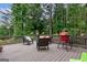 Relaxing outdoor deck furnished with comfortable seating and a red grill, perfect for entertaining at 405 Woodbrook Way, Lawrenceville, GA 30043