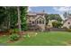 Spacious backyard with a deck, lush greenery, and a fenced-in area, perfect for entertaining at 405 Woodbrook Way, Lawrenceville, GA 30043