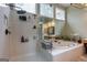 Modern bathroom featuring a walk-in shower, soaking tub, and dual windows for natural light at 405 Woodbrook Way, Lawrenceville, GA 30043