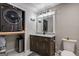 Chic bathroom featuring a dark wood vanity, built-in washer/dryer, and stylish fixtures at 405 Woodbrook Way, Lawrenceville, GA 30043