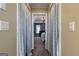 Hallway view leading to a serene bedroom with natural light and a decorative chandelier at 405 Woodbrook Way, Lawrenceville, GA 30043