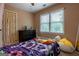 Bedroom with natural light, patterned bedding, and carpet at 405 Woodbrook Way, Lawrenceville, GA 30043