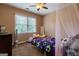 Bedroom featuring bright window and vibrant bedding at 405 Woodbrook Way, Lawrenceville, GA 30043