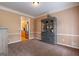 A formal dining room space with traditional wainscotting and molding, and a view to the kitchen at 405 Woodbrook Way, Lawrenceville, GA 30043