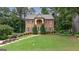 Charming two-story brick home featuring manicured lawn and inviting entrance at 405 Woodbrook Way, Lawrenceville, GA 30043