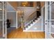 Welcoming foyer with hardwood floors, a staircase with wrought iron railings, and natural light at 405 Woodbrook Way, Lawrenceville, GA 30043