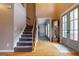 Bright foyer with hardwood flooring and a staircase; the entryway features a classic grandfather clock at 405 Woodbrook Way, Lawrenceville, GA 30043
