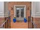 Close-up of the front entrance with a brick facade, stylish doors, and decorative planters at 405 Woodbrook Way, Lawrenceville, GA 30043
