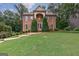 Charming brick home with well-manicured lawn and landscaping, creating a welcoming curb appeal at 405 Woodbrook Way, Lawrenceville, GA 30043
