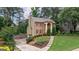 Inviting brick home with landscaped front yard and elegant architectural details, showcasing its charm at 405 Woodbrook Way, Lawrenceville, GA 30043