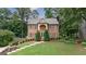 Charming brick two-story home with a manicured lawn and beautiful landscaping at 405 Woodbrook Way, Lawrenceville, GA 30043