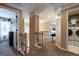 Upstairs hallway with access to bedrooms and laundry, featuring crown molding and neutral paint at 405 Woodbrook Way, Lawrenceville, GA 30043