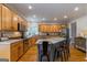 Open kitchen featuring wood cabinets, stainless steel appliances, granite counters and hardwood flooring at 405 Woodbrook Way, Lawrenceville, GA 30043
