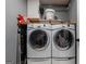 Laundry room featuring side-by-side washer and dryer units, with overhead storage at 405 Woodbrook Way, Lawrenceville, GA 30043
