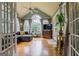 Sunroom living room featuring hardwood floors, many windows, vaulted ceiling and a gray sectional sofa at 405 Woodbrook Way, Lawrenceville, GA 30043