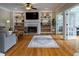 Bright living room with built-in shelves, a fireplace, hardwood floors, and natural light at 405 Woodbrook Way, Lawrenceville, GA 30043