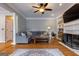 Comfortable living room with hardwood floors, a fireplace, built-in shelves, and a cozy sectional sofa at 405 Woodbrook Way, Lawrenceville, GA 30043