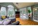 Living room featuring hardwood floors, many windows, vaulted ceiling and a gray sectional sofa at 405 Woodbrook Way, Lawrenceville, GA 30043