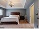 Spacious main bedroom has a tray ceiling, dark wood furniture, and neutral colored carpet at 405 Woodbrook Way, Lawrenceville, GA 30043