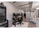 Well-lit office space with a modern desk setup and neutral walls, accented by a coffered ceiling and hardwood-style floor at 405 Woodbrook Way, Lawrenceville, GA 30043