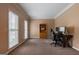 The home office features a dark wood desk and storage cabinet; and it has dual windows with blinds at 405 Woodbrook Way, Lawrenceville, GA 30043
