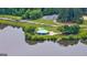 Lakeside pavilion with a green roof and covered picnic area, surrounded by tranquil water at 405 Woodbrook Way, Lawrenceville, GA 30043