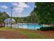 Community pool with seating and lake in background at 405 Woodbrook Way, Lawrenceville, GA 30043