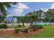 Community pool with seating, sun umbrellas, and manicured landscaping at 405 Woodbrook Way, Lawrenceville, GA 30043