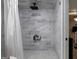 Elegant walk-in shower with gray tile, a rain shower head, and convenient storage niche at 405 Woodbrook Way, Lawrenceville, GA 30043