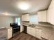 Modern kitchen featuring stainless steel appliances, granite countertops, and white cabinetry at 3948 Regent St, Douglasville, GA 30134