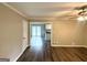Spacious living room featuring wood-look floors and ceiling fan, with a view into the adjacent kitchen at 3948 Regent St, Douglasville, GA 30134