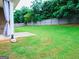 Spacious backyard with a well-maintained lawn, wood fence, and ample space for outdoor activities at 1243 Polk Xing, Mcdonough, GA 30252