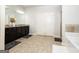 Bright bathroom featuring dual sinks, a soaking tub, and a walk-in shower at 1243 Polk Xing, Mcdonough, GA 30252
