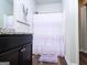 Bathroom featuring a granite vanity, framed mirror, and walk-in shower with a purple shower curtain at 1243 Polk Xing, Mcdonough, GA 30252