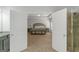 An entryway shows a doorway to a bedroom, and a bright bathroom with an open door to a tiled shower at 1243 Polk Xing, Mcdonough, GA 30252