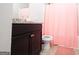 Bathroom featuring dark cabinets, a granite counter, and a shower with a pink curtain at 1243 Polk Xing, Mcdonough, GA 30252