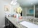 Bathroom vanity featuring granite countertops, dual sinks, and updated lighting at 1243 Polk Xing, Mcdonough, GA 30252