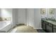 Modern bathroom featuring a bathtub, tile accent wall, and dual sink vanity with granite countertops at 1243 Polk Xing, Mcdonough, GA 30252
