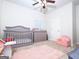 bedroom with crib, changing table, and pastel-colored decor at 1243 Polk Xing, Mcdonough, GA 30252