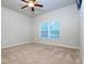 Bedroom with a large window that provides great natural light and neutral-colored carpet at 1243 Polk Xing, Mcdonough, GA 30252