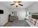 Well-lit bedroom features a stylish bed with decorative pillows and a ceiling fan at 1243 Polk Xing, Mcdonough, GA 30252