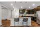 Elegant kitchen with a large island, granite countertops, stainless steel appliances, and dark cabinets at 1243 Polk Xing, Mcdonough, GA 30252