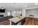 Kitchen island with a granite countertop, stainless steel sink, and pendant lighting at 1243 Polk Xing, Mcdonough, GA 30252
