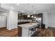 Spacious kitchen boasting dark cabinetry, stainless steel appliances, granite countertops, and a pantry at 1243 Polk Xing, Mcdonough, GA 30252