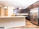 Well-equipped kitchen boasts a central island, stainless appliances, and dark wood cabinets at 1243 Polk Xing, Mcdonough, GA 30252