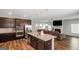 Open-concept kitchen with an island, stainless steel appliances, and seamless flow into the living area at 1243 Polk Xing, Mcdonough, GA 30252