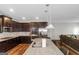 Modern kitchen featuring stainless steel appliances, granite countertops, dark cabinetry, and hardwood floors at 1243 Polk Xing, Mcdonough, GA 30252